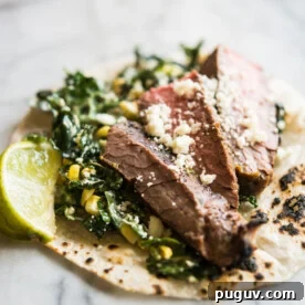 Beef carne asada on top of kale and slaw.