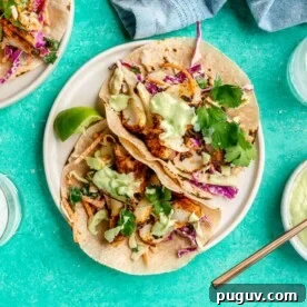 Two plates of blackened fish tacos.