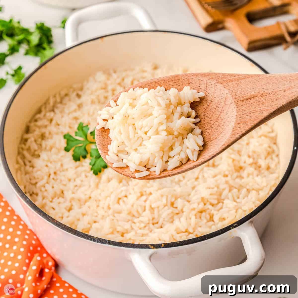 white pot filled with rice and wood spoon removing a scoop