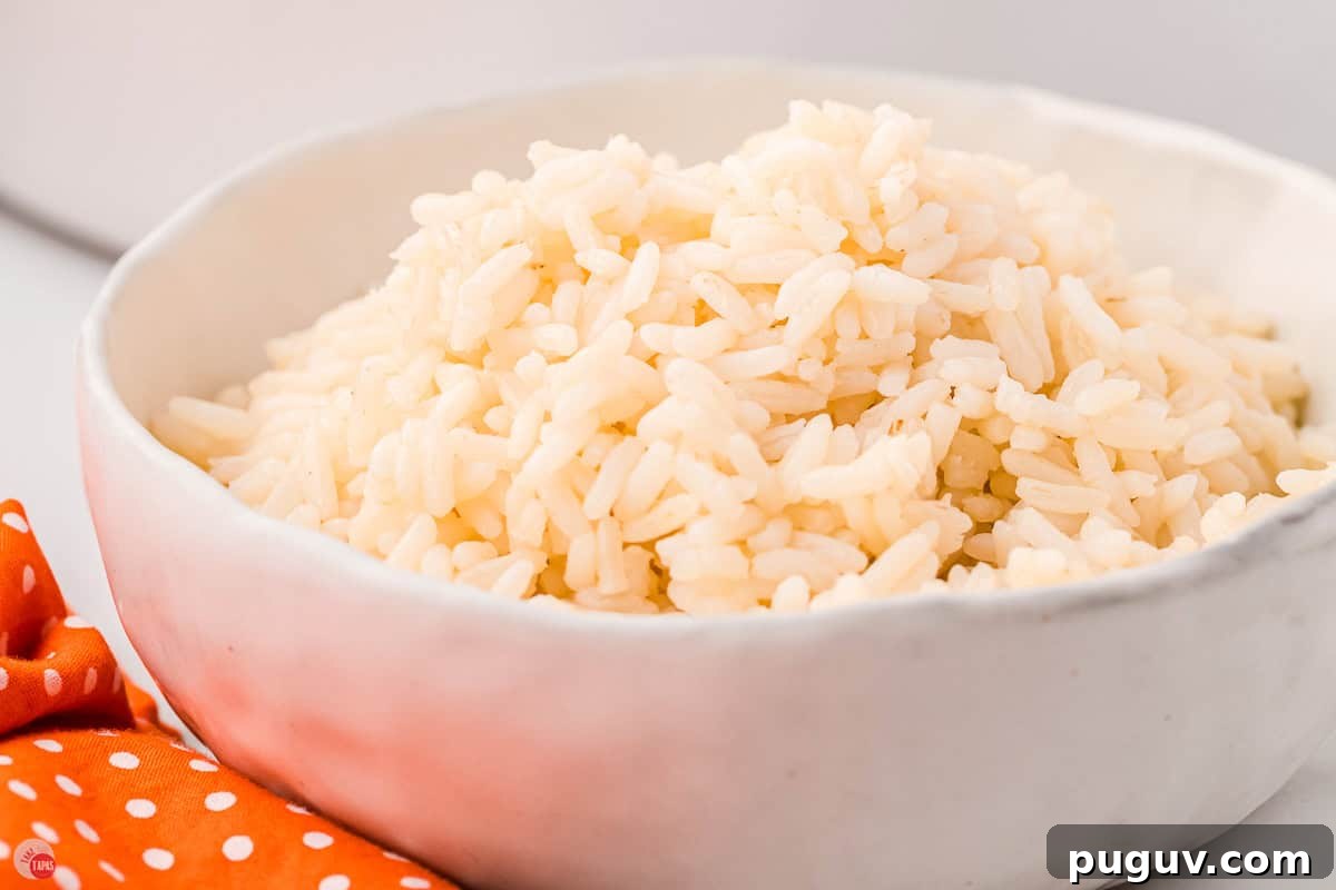 close up of bowl of white rice with an orange napkin