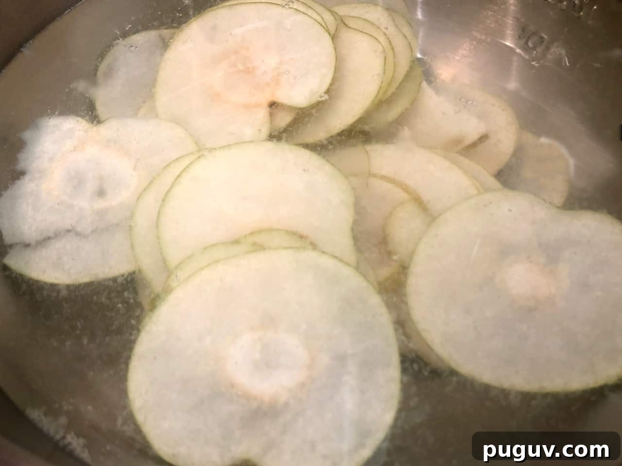 sliced asian pears in lemon water.