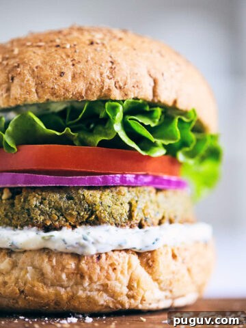 Falafel burger with tzatziki on a wooden serving board