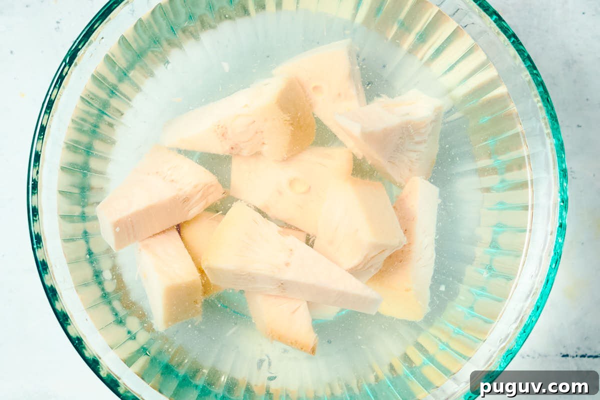 Canned jackfruit soaking in a glass bowl of water.