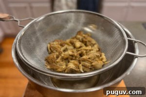 Smoked Baba Ganoush Recipe: Creamy Charred Eggplant Dip 11 Roasted eggplant flesh in a strainer to drain excess moisture.