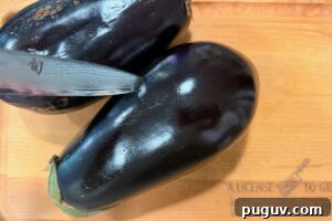 Smoked Baba Ganoush Recipe: Creamy Charred Eggplant Dip 8 Piercing skin of eggplant with a knife.