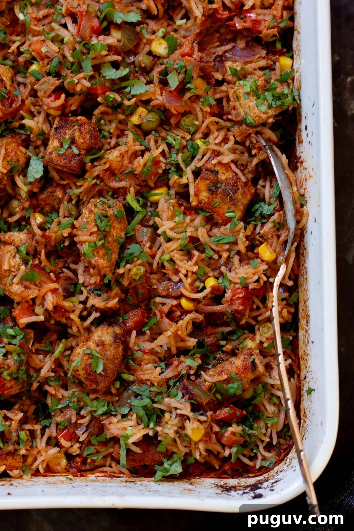 Crispy Tofu Tikka Masala Rice Bake Recipe 4 close-up of tikka masala rice in the baking pan after baking and fluffing