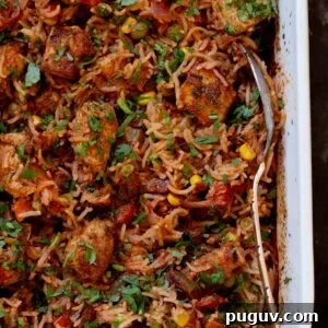 Crispy Tofu Tikka Masala Rice Bake Recipe 6 close-up of tikka masala rice in the baking pan after baking and fluffing