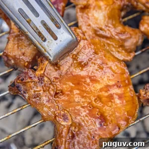 Grilled Huli Huli Pork Chops with Sweet Pineapple Glaze 3 pork chops on the grill