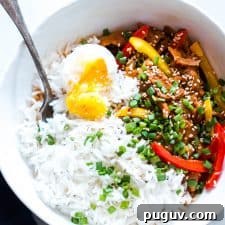 Slow Cooker Gochujang Korean Pork Bulgogi Recipe 5 Slow Cooker Korean Pork Bulgogi with Gochujang served with egg and rice in a white bowl.