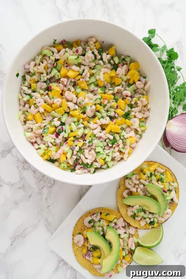overhead shot of a large bowl of shrimp ceviche and a plate of tostadas topped with shrimp ceviche and avocados