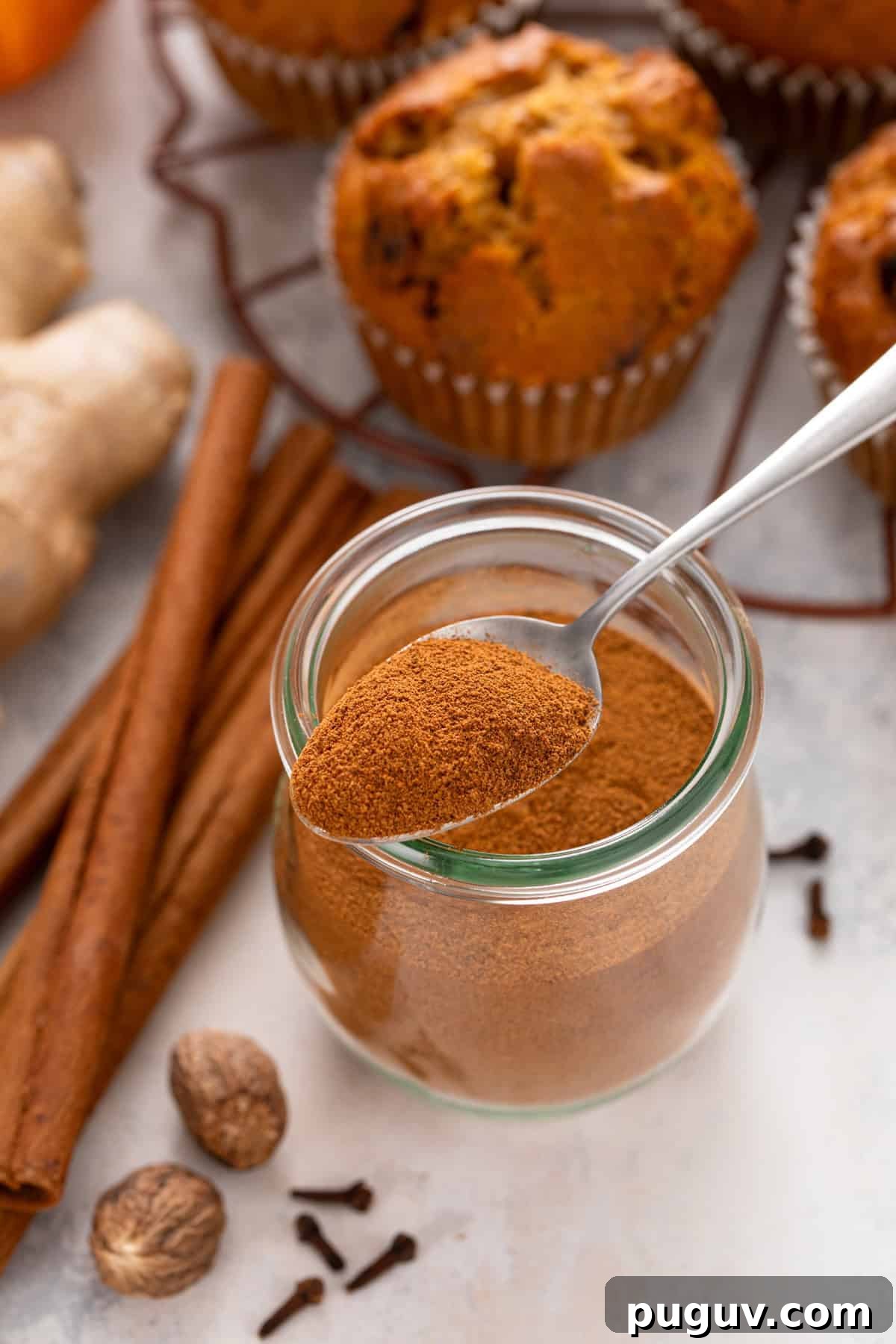 How to Make Pumpkin Pie Spice at Home for Cozy Fall Baking 2 Jar of pumpkin pie spice with a spoonful of the spice balancing on the top.