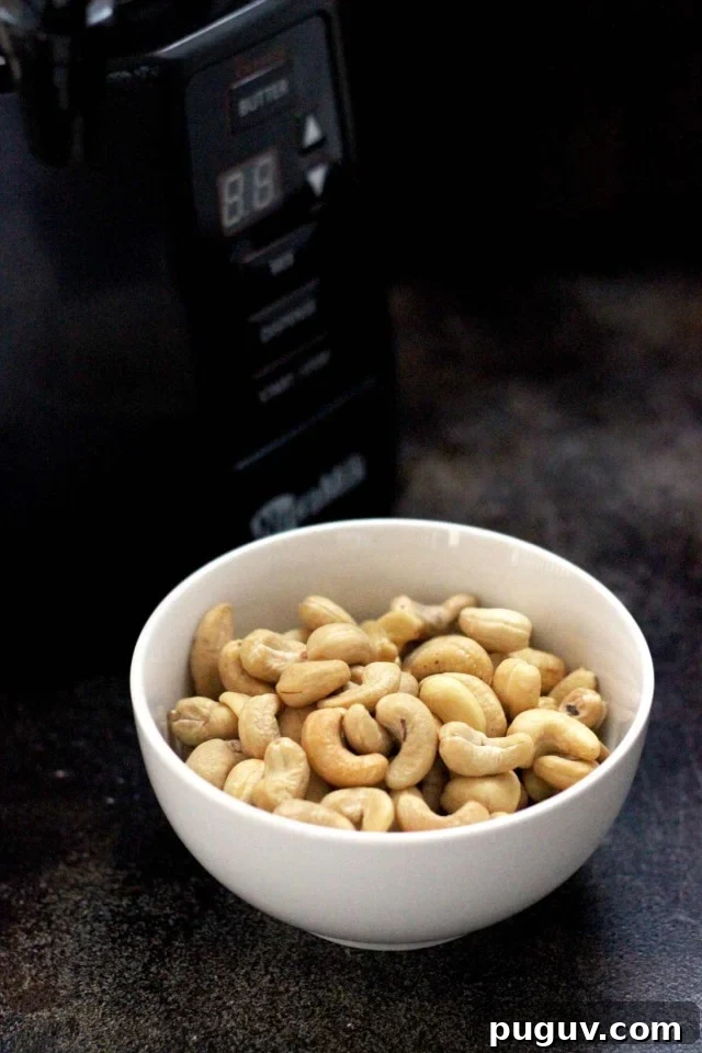 Healthy Vegan Pumpkin Spice Latte - The NutraMilk and a Bowl of Cashews on the Dark Table