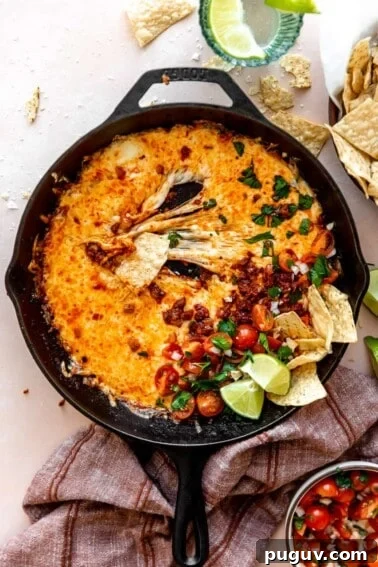 Loaded Texas Nachos Recipe: How to Make Classic Tex-Mex Nachos 11 stretchy melted cheese in a skillet with chorizo and pico de Gallo.