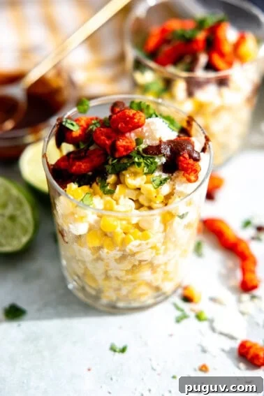 Loaded Texas Nachos Recipe: How to Make Classic Tex-Mex Nachos 14 Esquites, Mexican street corn in a cup, topped with queso fresco, hot Cheetos, fresh cilantro and a chile sauce.
