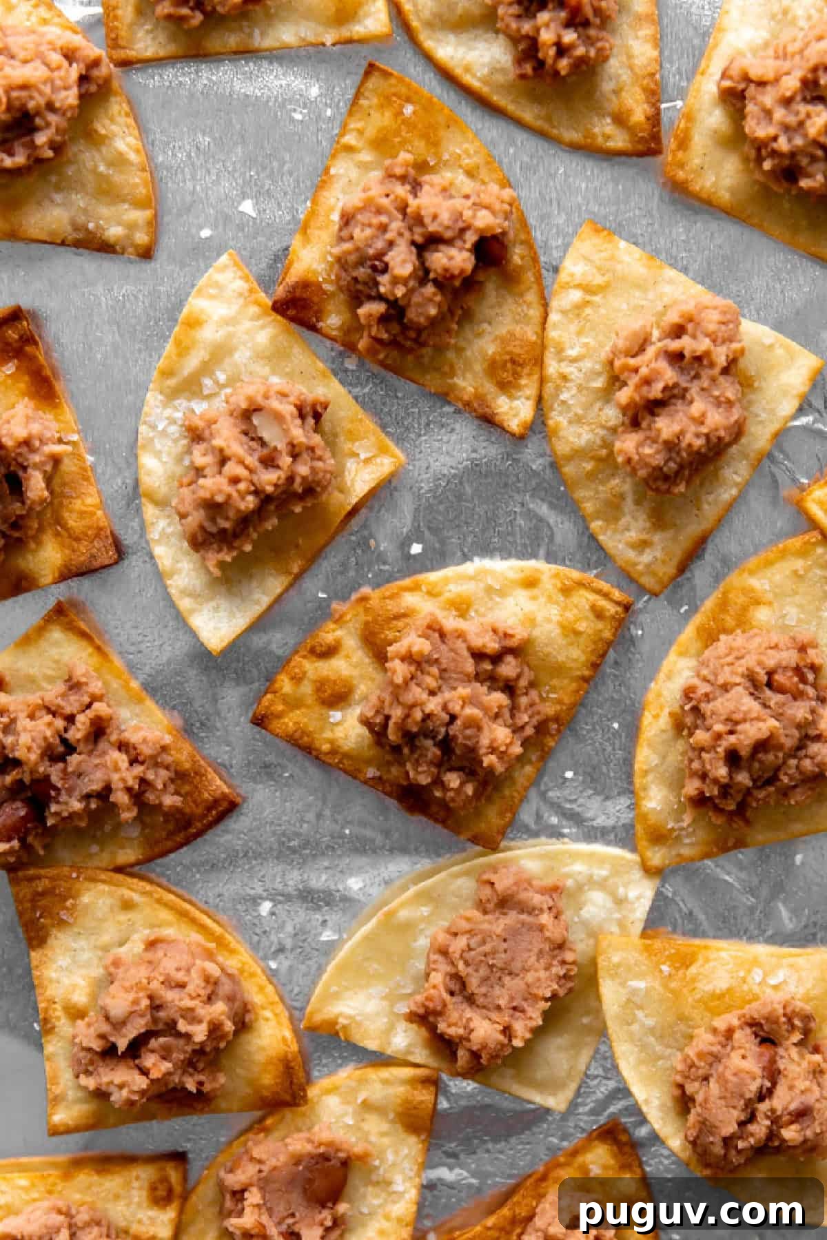 Loaded Texas Nachos Recipe: How to Make Classic Tex-Mex Nachos 8 Tortilla chips topped with refried beans.