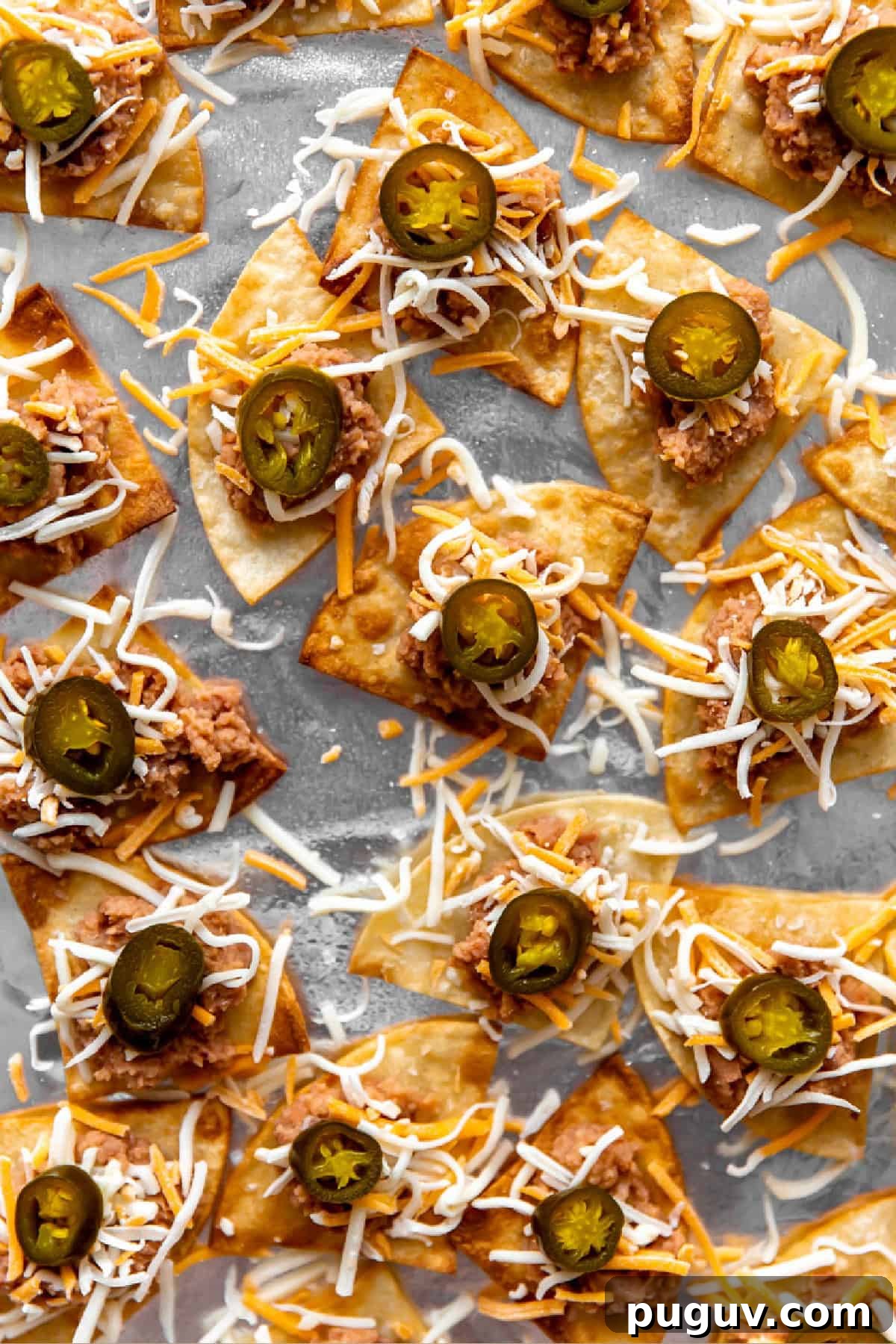 Loaded Texas Nachos Recipe: How to Make Classic Tex-Mex Nachos 9 Tortilla chips topped with refried beans, grated cheese, and pickled jalapeños.