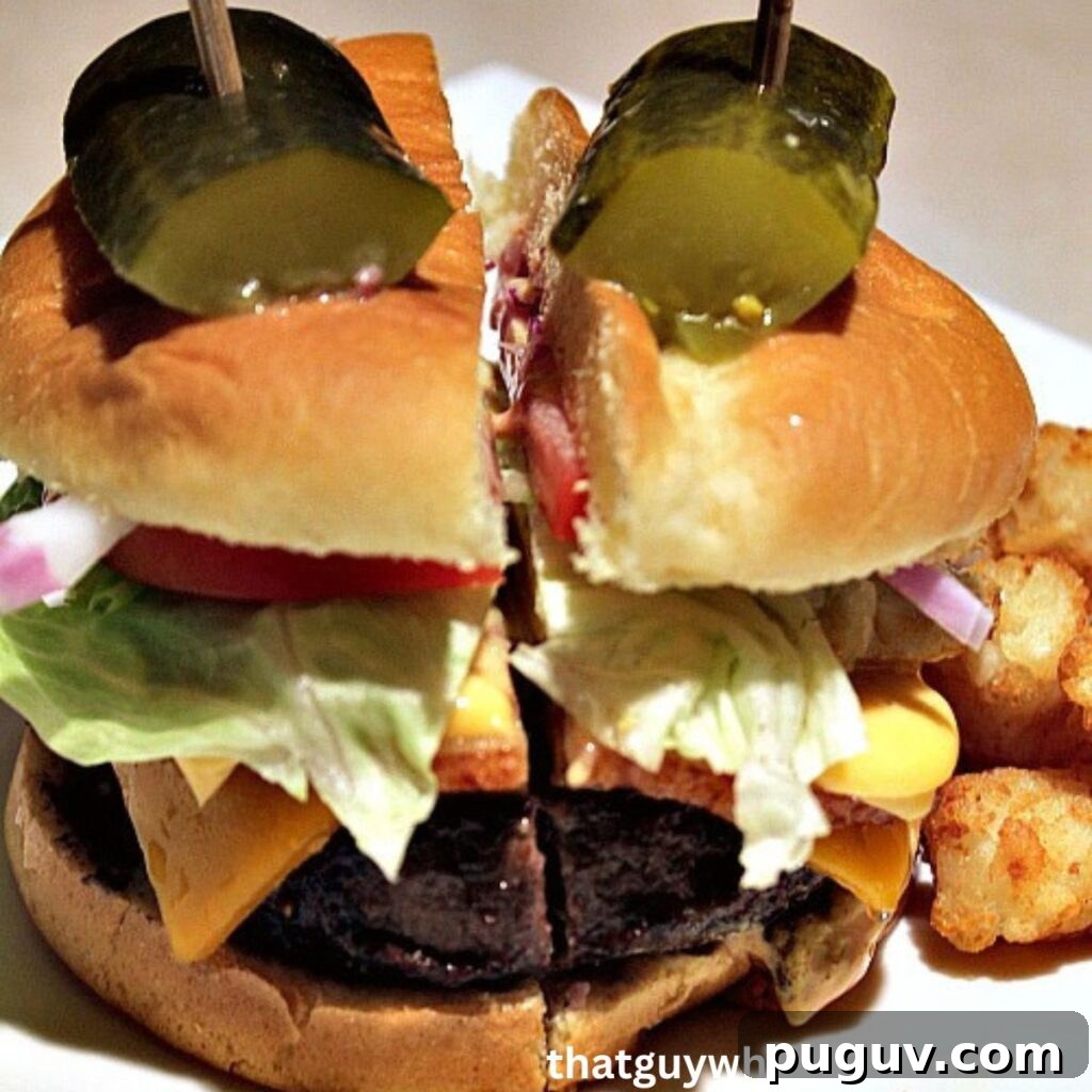 Grill a Perfect Burger: Tips for Juicy, Evenly Cooked Patties 2 Assembled Burger On A White Plate