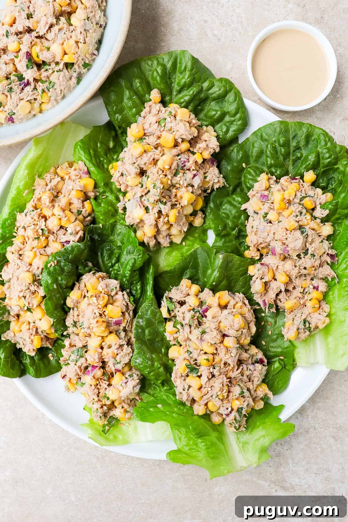 Tuna and corn salad on lettuce leaves.
