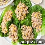 Tuna and corn salad on lettuce leaves.