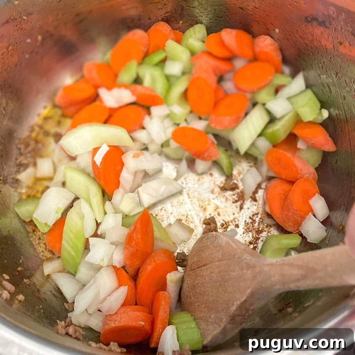 Creamy Instant Pot Tortellini Soup Recipe for Quick Weeknights 6 Carrot, celery, and onion are stirred in the Instant Pot.
