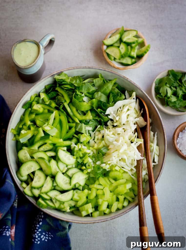 Crisp Green Goddess Salad with Avocado and Herb Dressing 2 green goddess salad in a wooden bowl