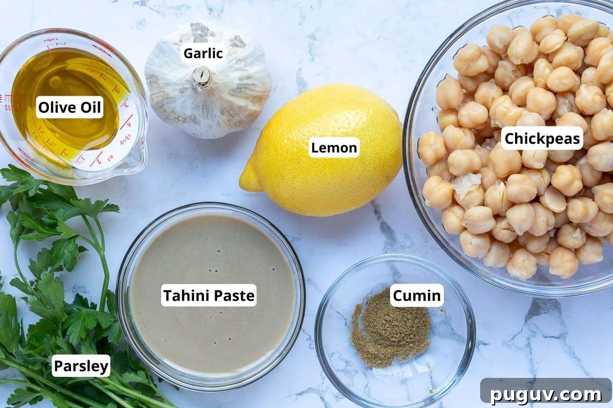 Creamy Roasted Garlic Hummus Recipe for Smooth, Flavorful Dip 3 olive oil, garlic, lemon, parsley, tahini, cumin, and chickpeas.