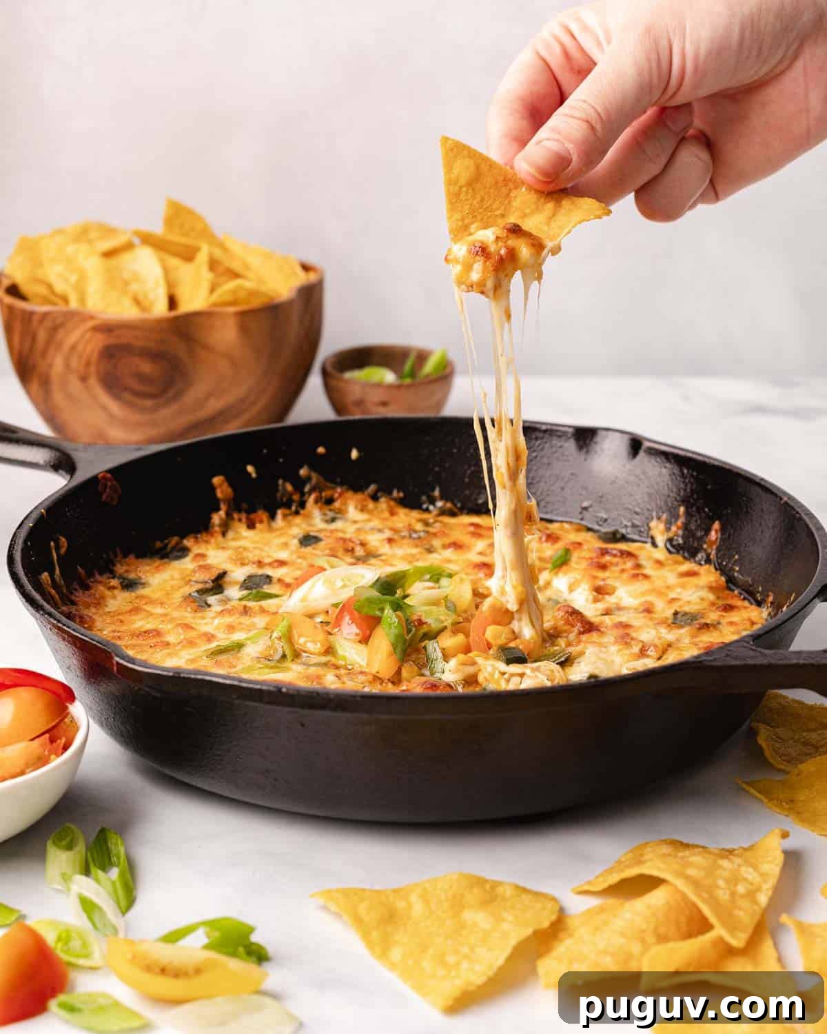 chip dipping into cheese
