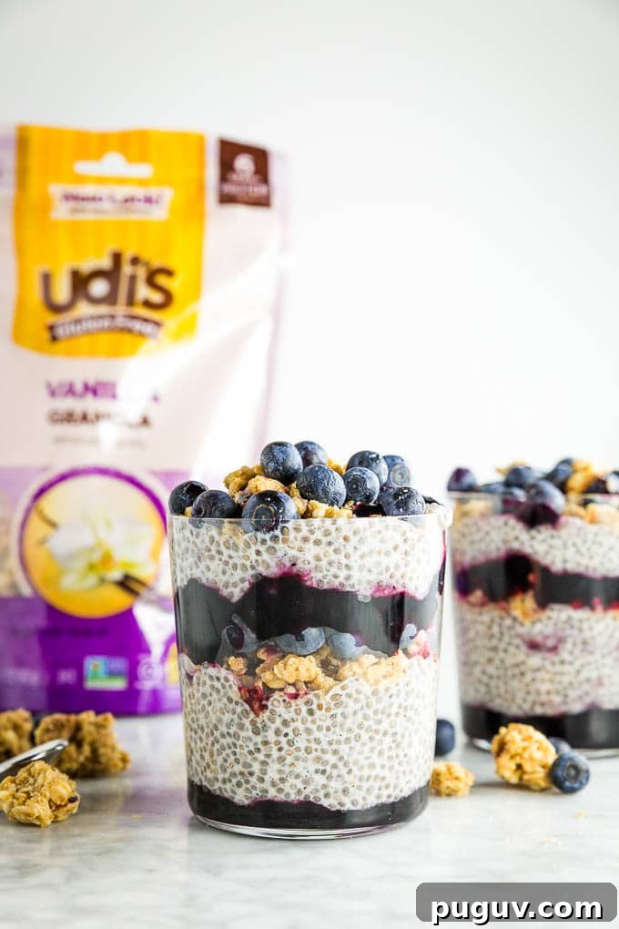Berry Chia Pudding with Crunchy Granola Bowl PMID 3 A glass of chia seed pudding layered with Udi's granola, blueberry jam and fresh blueberries with a bag of Udi's Gluten Free Vanilla Granola in the background.
