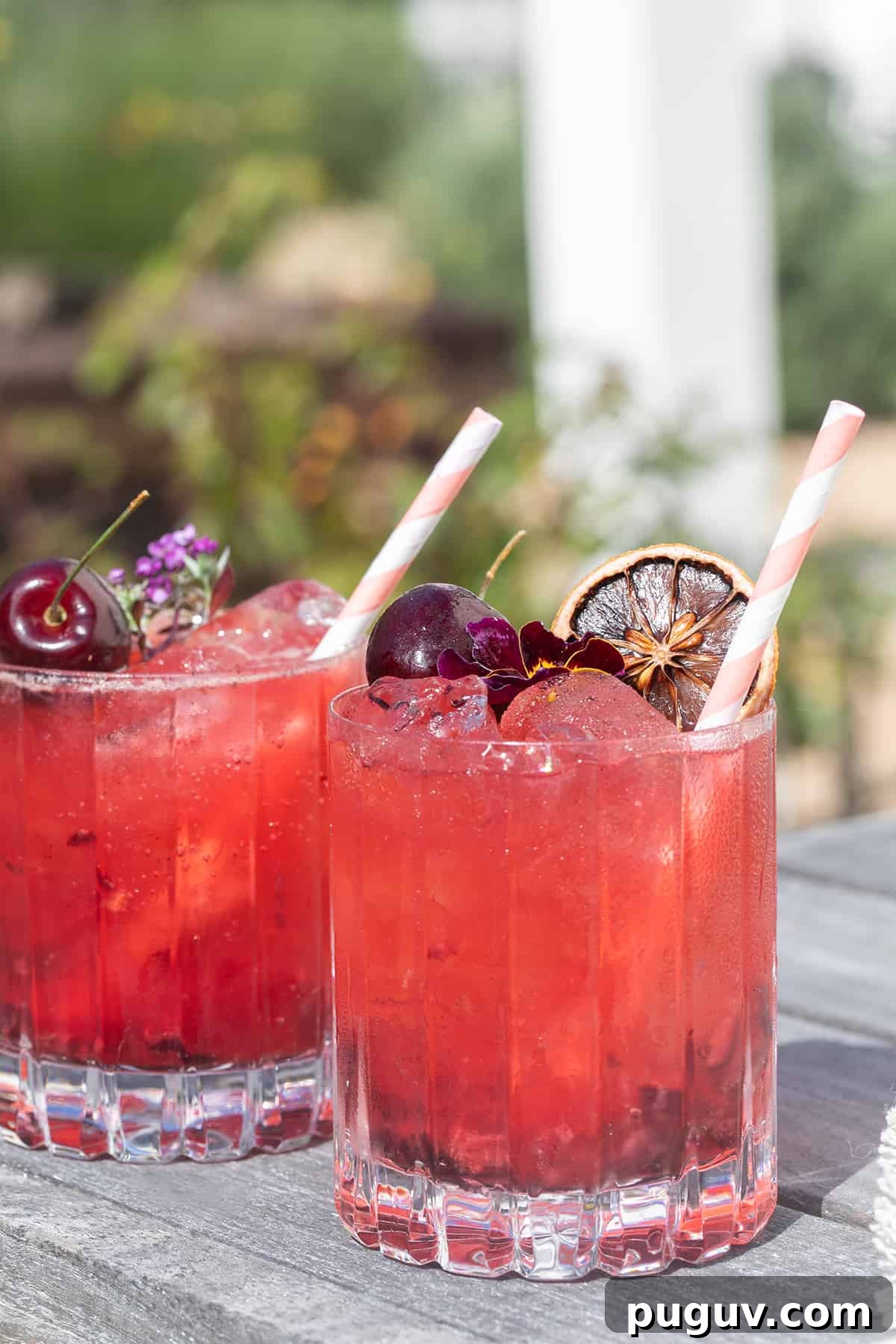 Summer cocktail made with cherries, gin, tonic water and lemon juice.