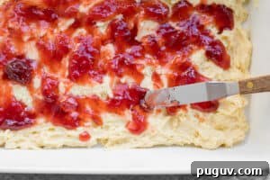 jam being spread over batter of coffee cake