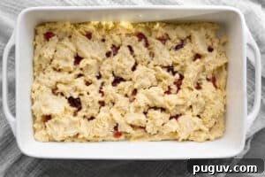 batter being spread on top layer of cake