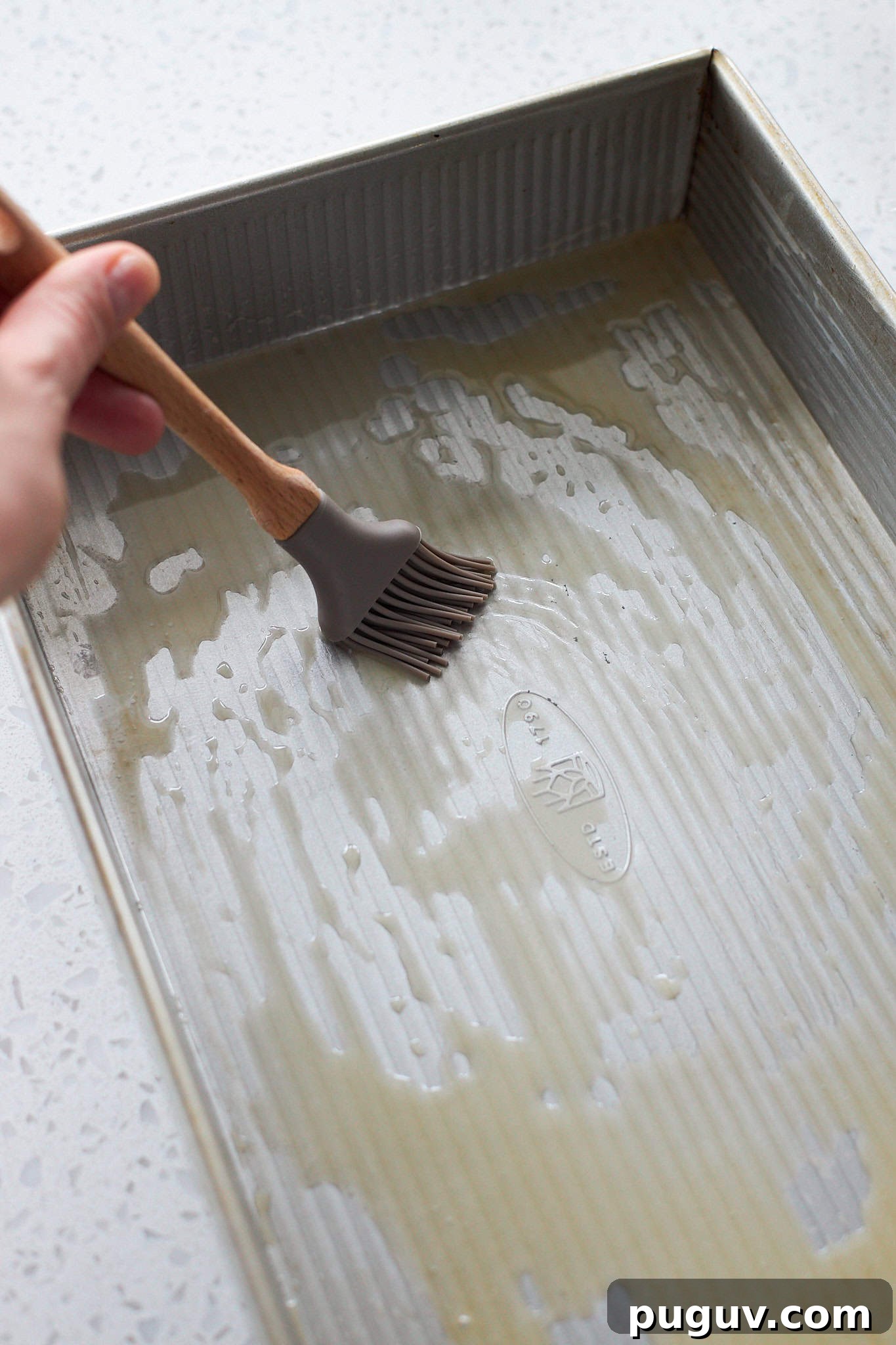 Sourdough Discard Cinnamon Roll Focaccia Recipe 7 Brushing the 9x13-inch baking pan with melted butter.