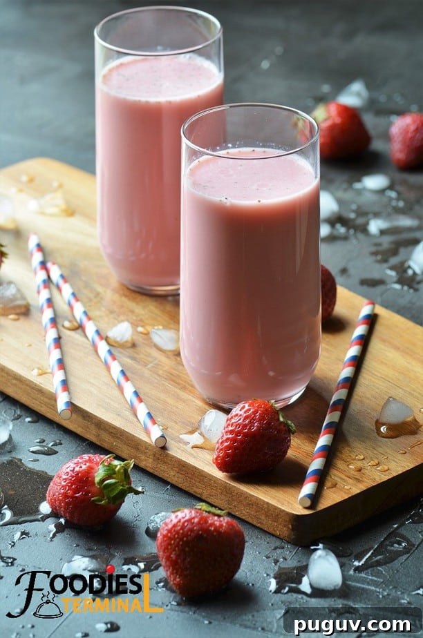 Refreshing Homemade Strawberry Lassi Recipe: Creamy Yogurt Drink 2 Strawberry Lassi in two glasses with straws by the side