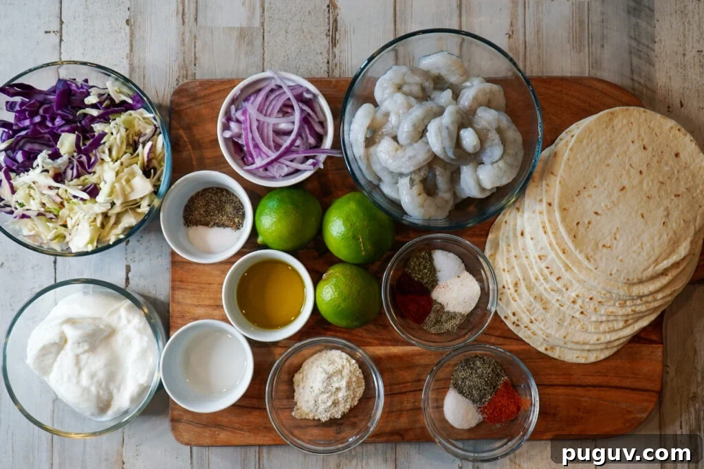 Cilantro-Lime Shrimp Tacos with Creamy Avocado Slaw 3 Ingredients for cilantro lime shrimp tacos. Cabbage, red onions, limes, sour cream, shrimp, spices and tortillas on a wood cutting board.