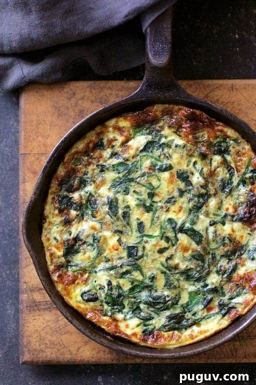 Spinach, Leek & Feta Frittata Recipe for Brunch or Dinner 2 Photo of Spinach Leek and Feta Cheese Frittata fresh from the oven in cast iron skillet on wood trivet.