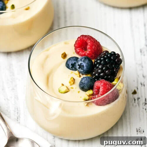A glass of custard with fruit