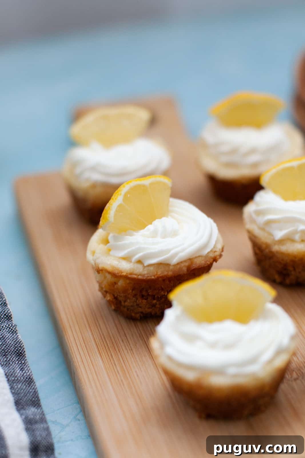 mini lemon cheesecakes on a wood board