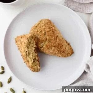 Brown Sugar Cardamom Scones Recipe for Tender, Buttery Pastries 13 Brown Sugar Cardamom Scones on a white plate next to cardamom pods.