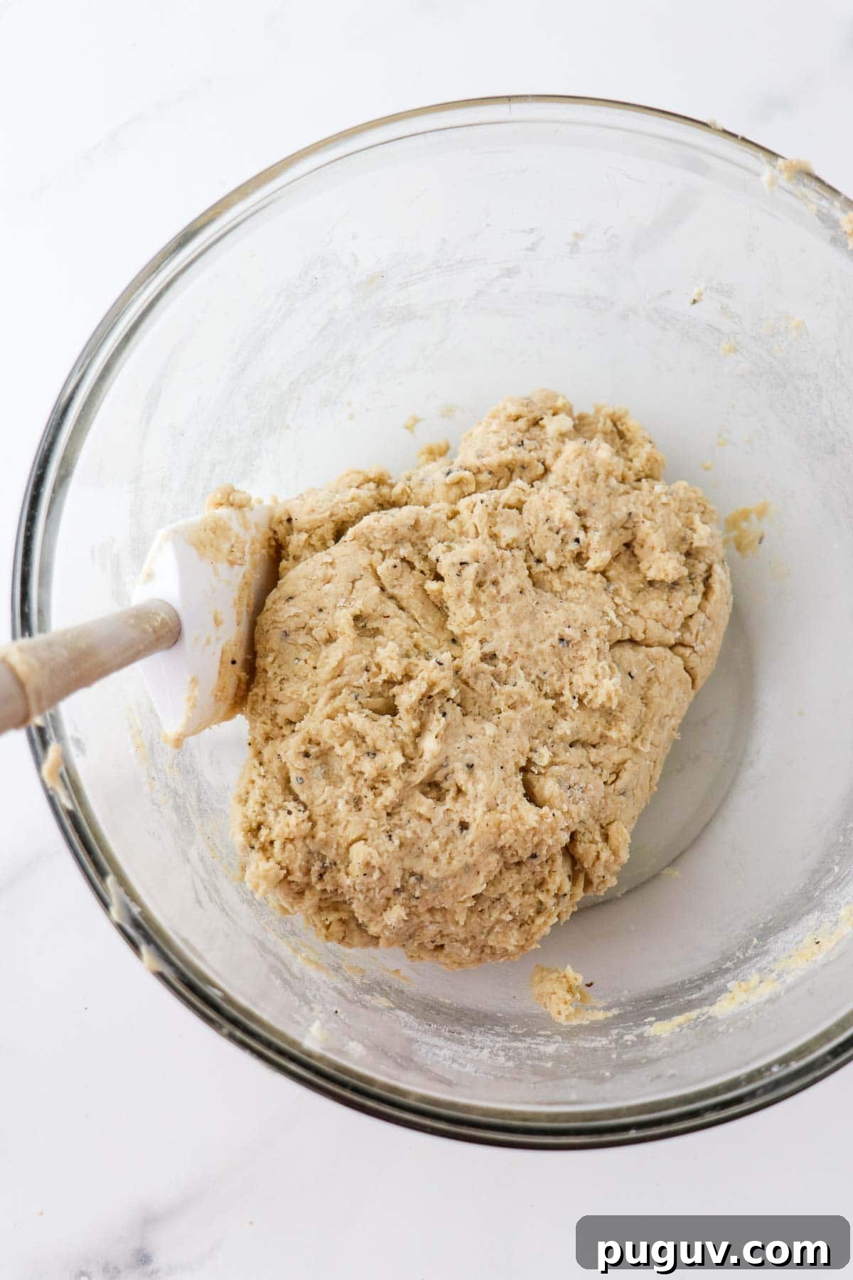 Brown Sugar Cardamom Scones Recipe for Tender, Buttery Pastries 6 Brown Sugar Cardamom Scone Dough in a glass bowl with a rubber spatula.
