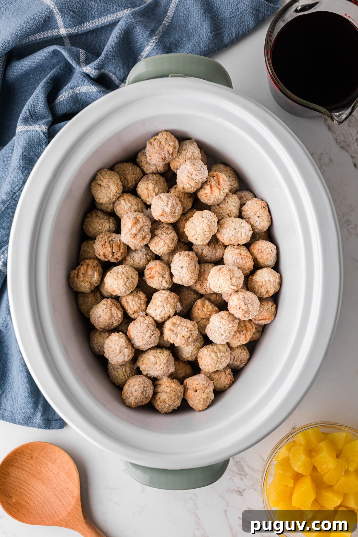 Frozen meatballs in a slow cooker.