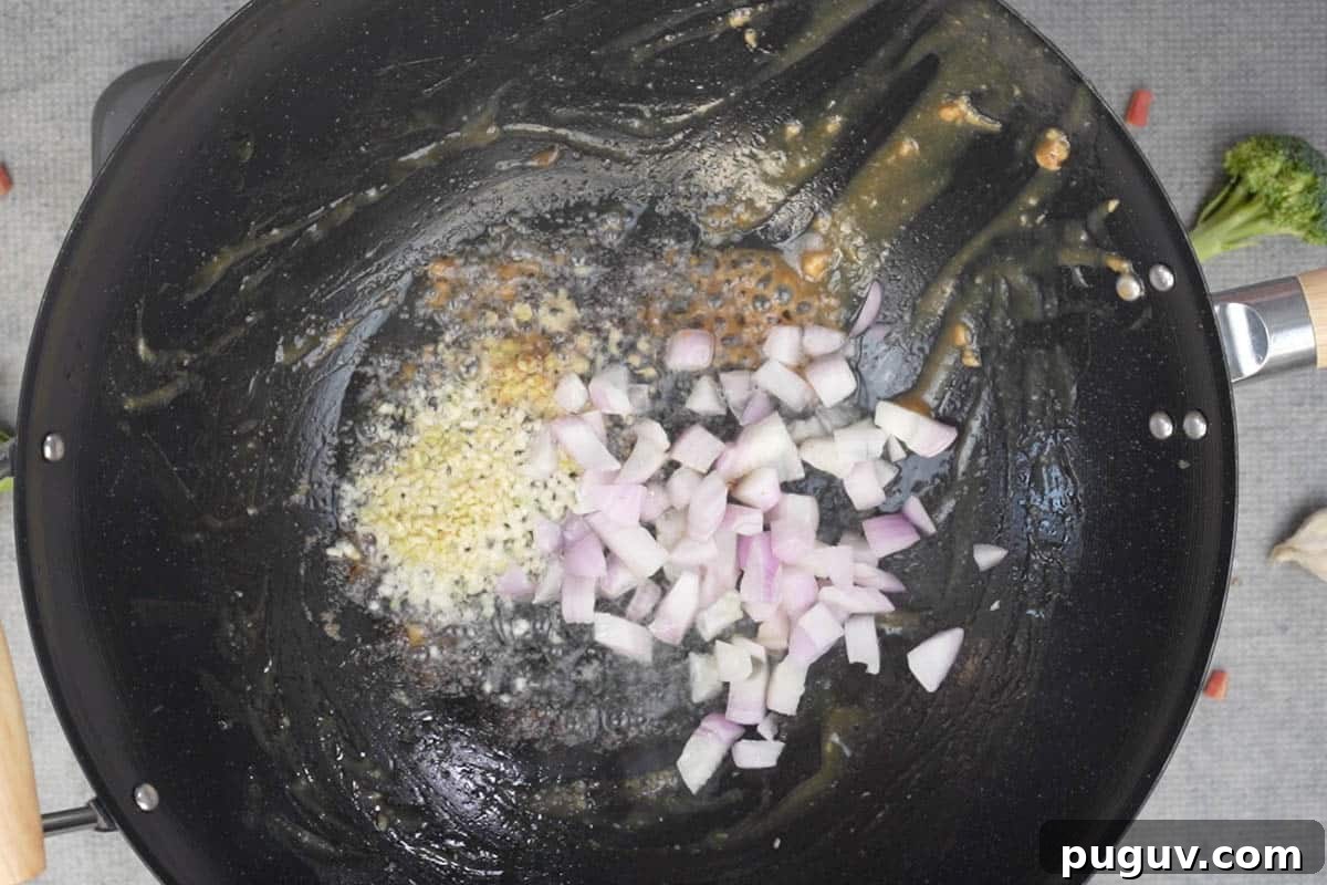 Onion, ginger and garlic in wok.