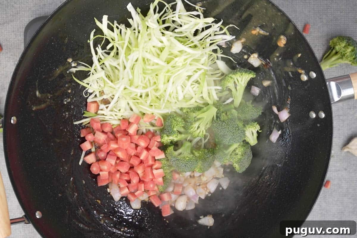 Veggies added to the wok.
