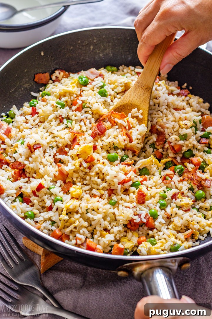 Serving Bacon Fried Rice with wooden spoon