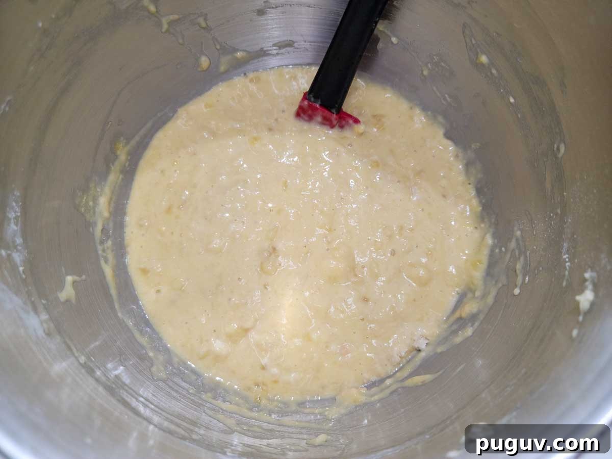 mashed banana, eggs, sugar, baking soda, and self-rising flour mixed in a bowl.