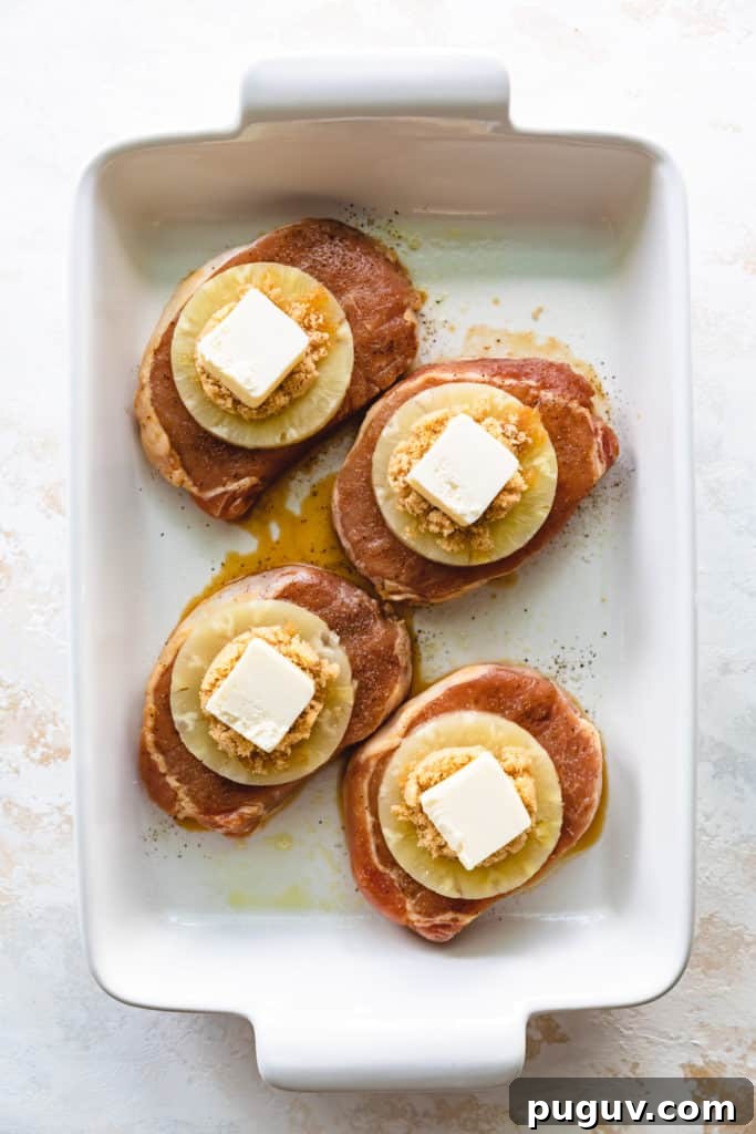 Pineapple, brown sugar, and butter on top of pork chops.