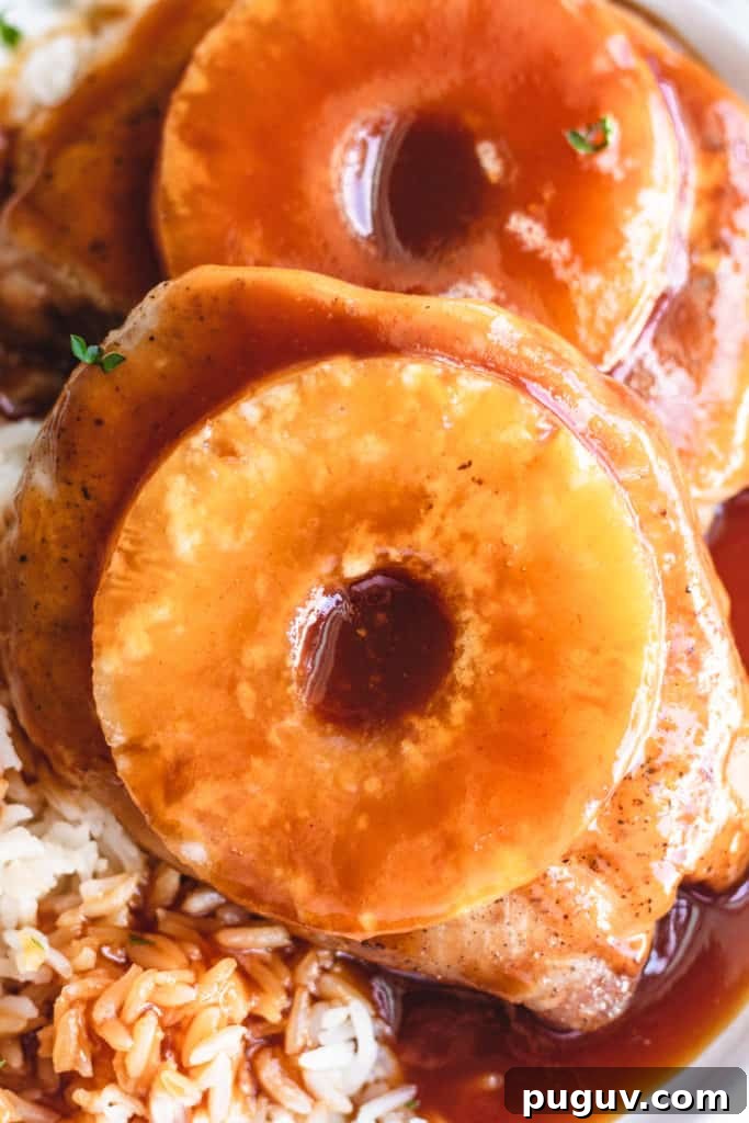 Close up view of baked pineapple pork chops on a plate.