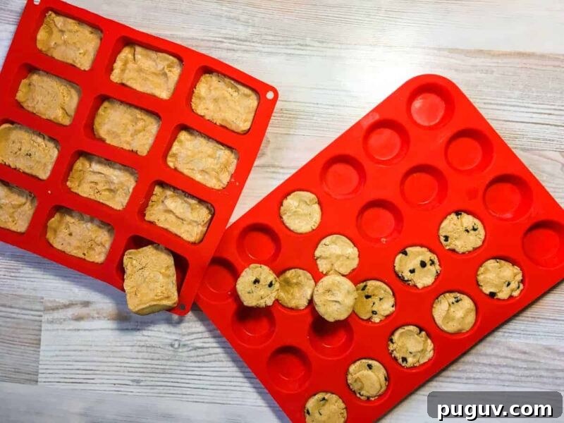 Two red silicon baking mats - one filled with rectangular peanut butter perfect bars and one filled with mini-muffin sized peanut butter perfect bars and peanut butter and chocolate chip perfect bars.