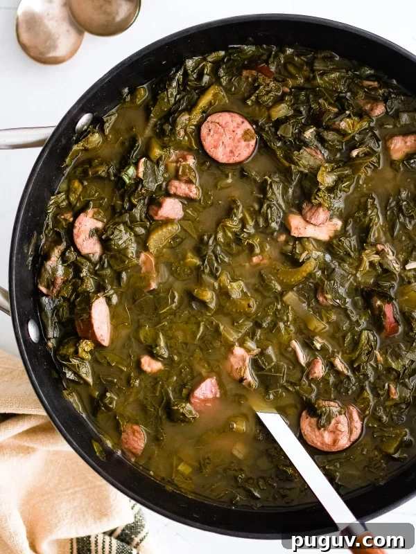 Green gumbo with sausage in pot next to bowl of rice