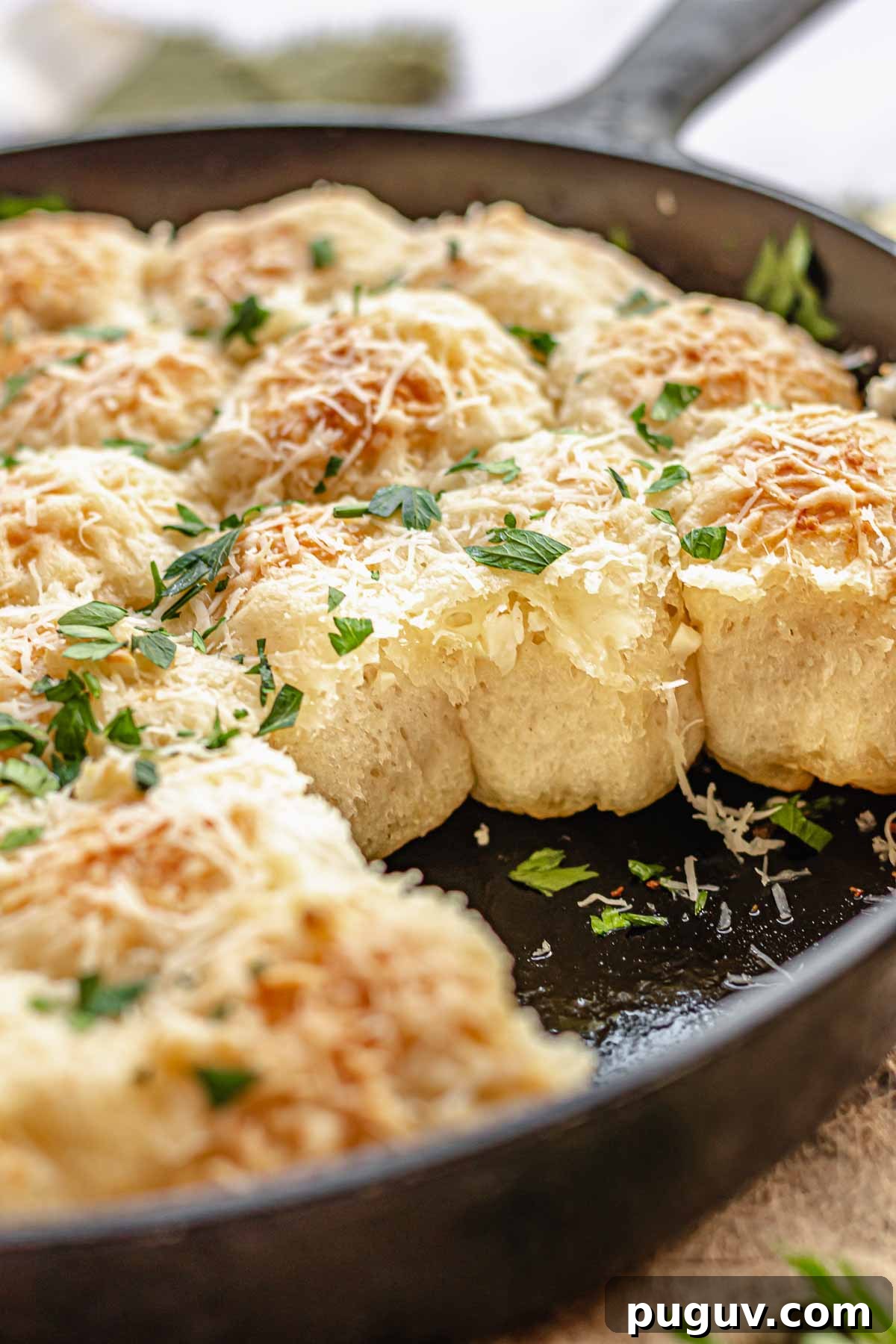 Bread bites in a pan. Some are removed so you can see the fluffy sides.