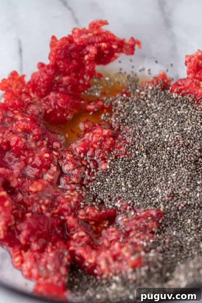 Mashed raspberries in a bowl